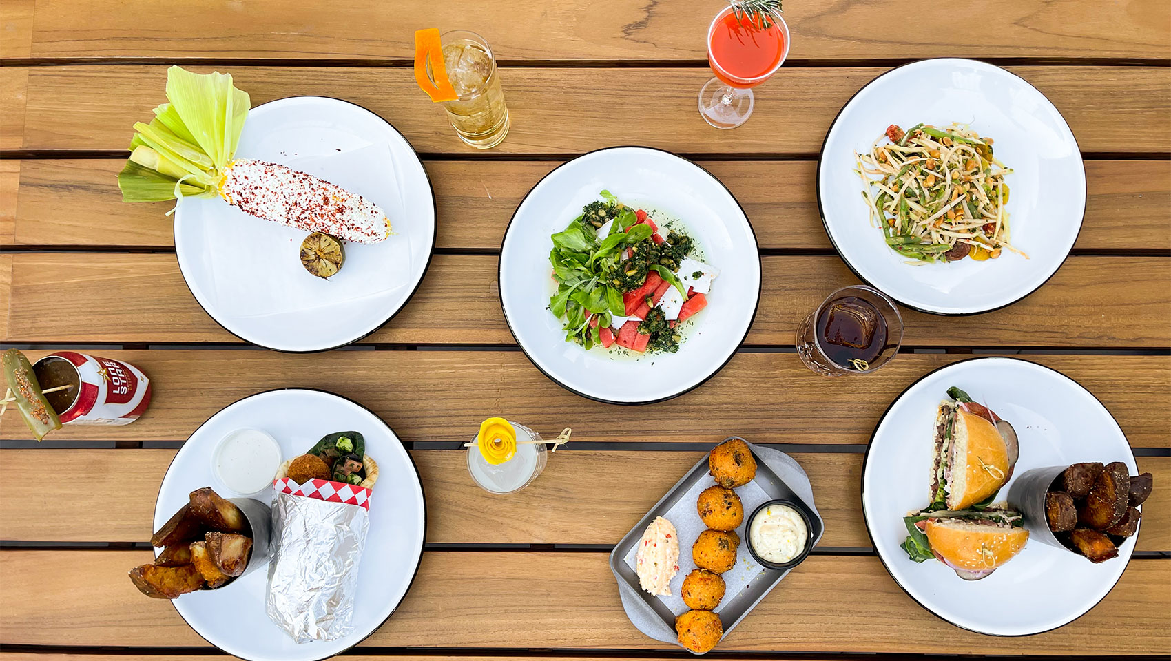 wooden table with plated entrée choices from Deep End