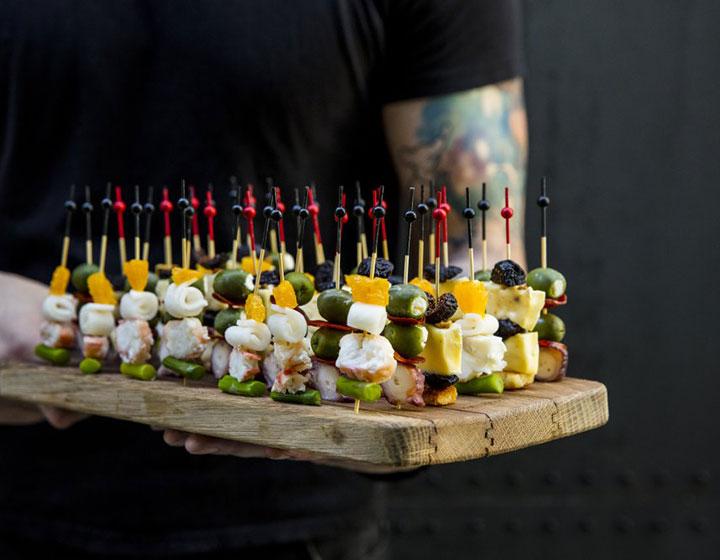 Small bites on toothpicks on a charcuterie board