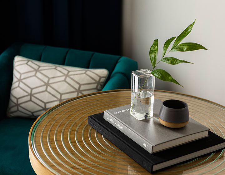 The Kimpton Pittman Hotel  side table with books and decor