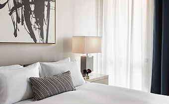The Kimpton Pittman Hotel bed and sidetable