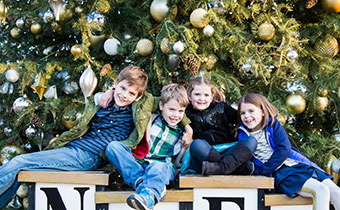 Children in front of outdoor holiday decorations