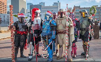 Characters in costume with holiday accessories posing for photo