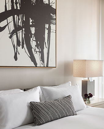 The Kimpton Pittman Hotel  guestroom seating area with dim reading lamp