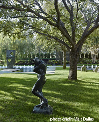 grassy park with stone statue